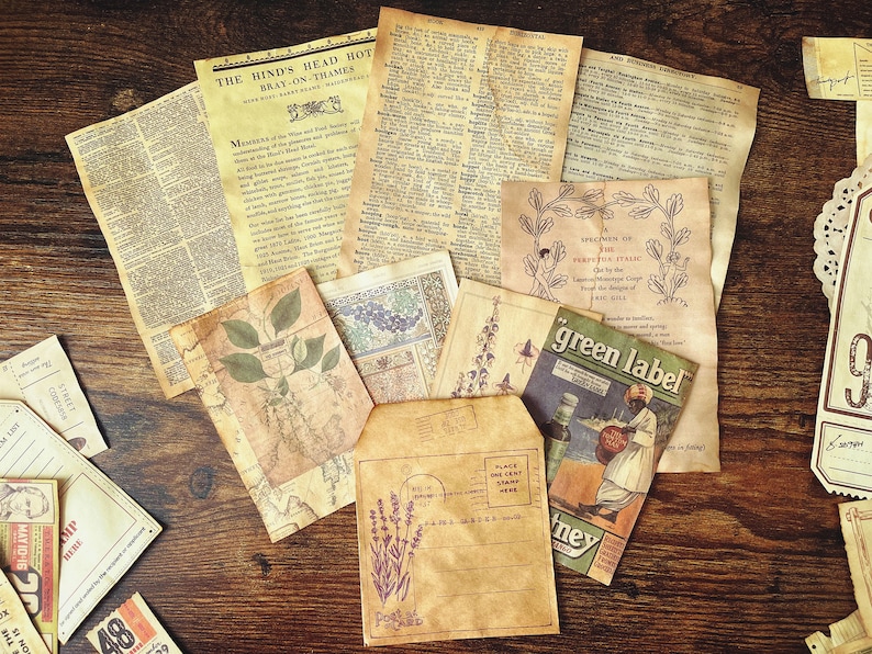 May include: A collection of vintage paper ephemera, including a postcard, a magazine cover, and several pages of text. The magazine cover features a green label and the text "green label" in white letters. The postcard is blank and has a floral design in the corner. The text pages are all yellowed with age and have various text printed on them.