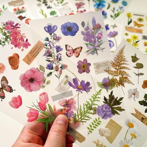 Pegatinas transferibles, 2 hojas con diseños florales, vegetales y de mariposas para usar en múltiples superficies, scrapbooking, diarios basura y efímeras.