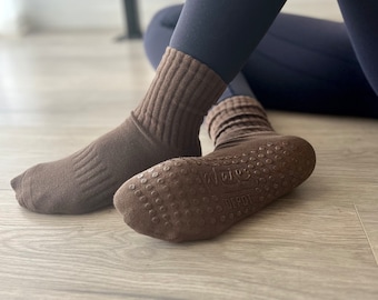 May include: A pair of brown grippy socks with a textured sole. The socks have a ribbed design and the text "DEPOT" is visible on the sole.