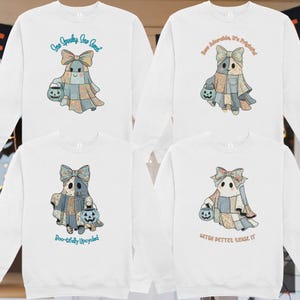 May include: White sweatshirts with a ghost graphic holding a jack-o'-lantern. Each ghost is wearing a patchwork quilt costume and a bow. Text on the sweatshirts reads: "Sew Spooky Sew Sweet", "Sew Adorable, It's Frightful!", "Boo-tifully Upcycled", and "Witch Better Rense It".