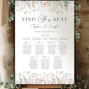 May include: A white wedding seating chart sign featuring the text FIND YOUR SEAT, Tophia & Joseph, and Saturday 29th August 2026. The design includes watercolour illustrations of wildflowers at the top and bottom edges.