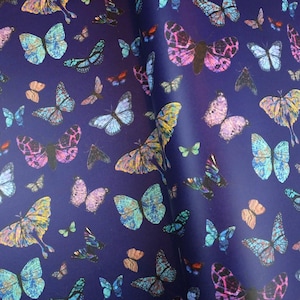 May include: A dark blue background is covered with a pattern of colorful butterflies. The butterflies vary in size and color, with hues of pink, blue, yellow, and green. The wings have detailed patterns.