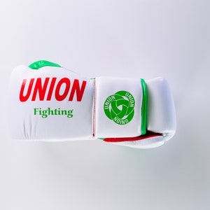 May include: White boxing glove with green and red trim. The glove has the words "UNION Fighting" printed on it.