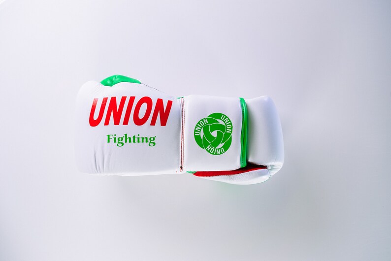 May include: White boxing glove with green and red trim. The glove has the words "UNION Fighting" printed on it.