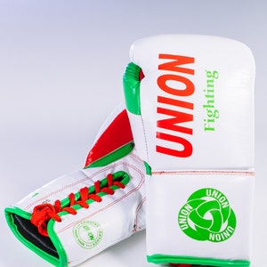 May include: White boxing gloves with red and green accents. The gloves have the word "UNION" in red and "Fighting" in green on the back. The gloves are laced up and have a green and white logo on the wrist.