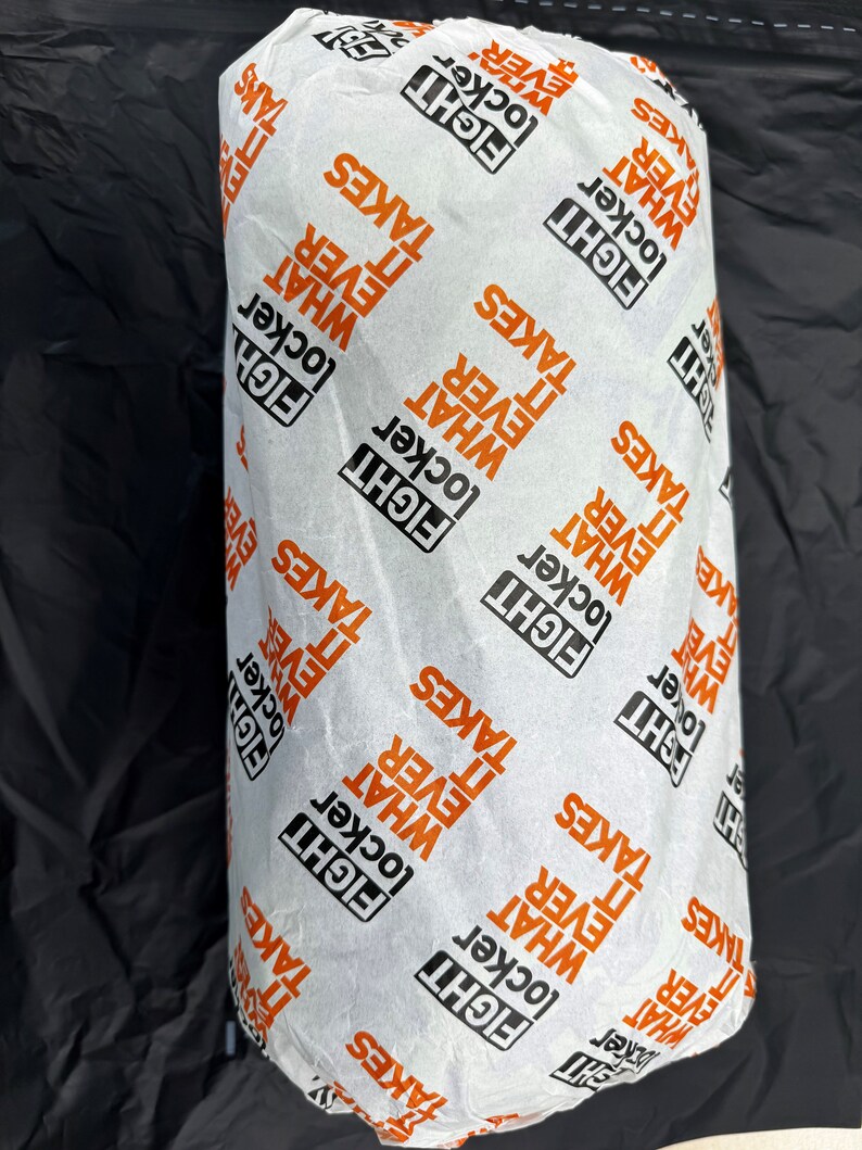 May include: White paper wrapping with a repeating pattern of the words "Fight", "Locker", "What", and "It Ever Takes".