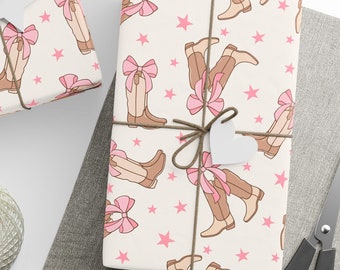 May include: Several gift-wrapped parcels with cream-coloured paper patterned with brown cowboy boots, pink bows and stars. The parcels are tied with twine and have white star and heart-shaped tags. A ball of twine and scissors are also visible.