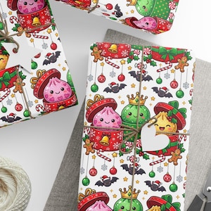 May include: White wrapping paper featuring a repeating pattern of cartoon dumplings in open gift boxes, gingerbread men, candy canes, Christmas ornaments, and bats wearing Santa hats. The paper is tied with twine and a white heart-shaped gift tag.