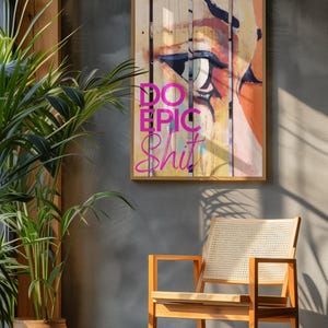 May include: A framed print with a colorful abstract painting of an eye and the text "DO EPIC SHIT" in pink letters.