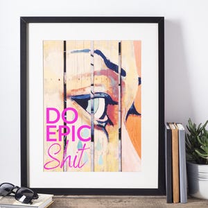 May include: A framed print with a colorful abstract painting of an eye and the text "DO EPIC SHIT" in pink.