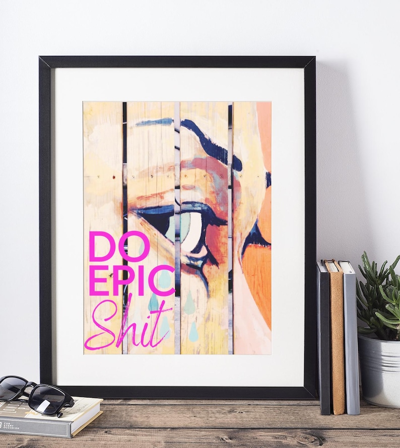 May include: A framed print with a colorful abstract painting of an eye and the text "DO EPIC SHIT" in pink.