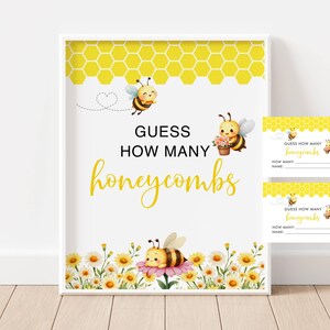 May include: A framed sign and two cards with a bee theme. The sign reads "Guess How Many Honeycombs" in yellow script. The sign has a yellow honeycomb pattern at the top and a floral border at the bottom. The cards have the same design.