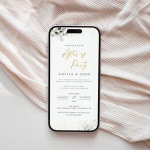 May include: A smartphone displays a wedding invitation with the words "Happily Ever After Party" in gold script. The invitation includes the names Amelia & John, event details, and floral accents. The phone rests on a beige fabric.