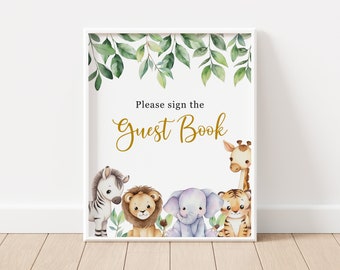May include: A white sign with a gold border and the text "Please sign the Guest Book" in gold lettering. The sign is decorated with a green leafy border and a row of cartoon animals including a zebra, lion, elephant, and tiger.