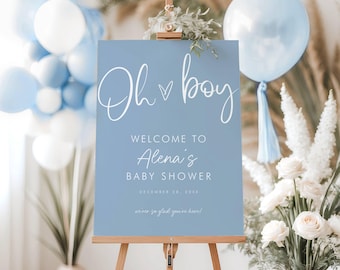 Pode incluir: Uma placa azul clara em um cavalete de madeira com as palavras "Oh boy" em escrita branca. A placa dá as boas-vindas aos convidados do chá de bebê de Alena, com a data de 28 de dezembro de 2048. Balões e arranjos florais decoram o fundo.