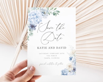 Puede incluir: Una tarjeta rectangular de Save the Date con hortensias azules en acuarela y vegetación. El texto dice Save the Date, Katie and David, Saturday, February 26th, The Perch, Tampa, Florida, y formal invitation to follow en color negro.