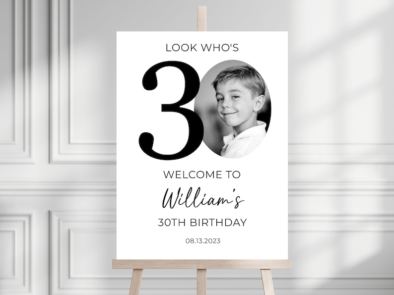 May include: Black and white welcome sign with a large number 30 and a photo of a young boy. The text reads "Look Who's 30, Welcome to William's 30th Birthday, 08.13.2023".