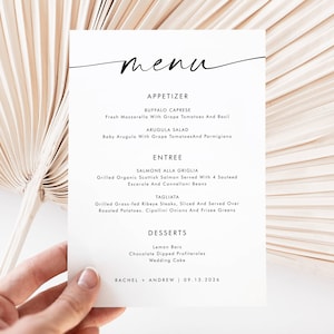 May include: A white menu card with black text, held by a hand. The menu lists appetizers, entrees, and desserts. The menu includes the names of the dishes and the date 09.13.2024.