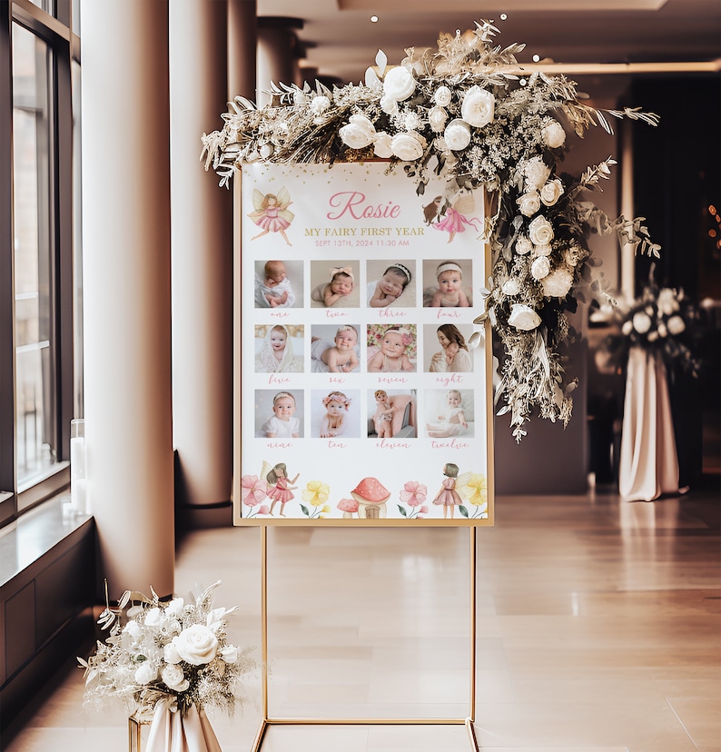 May include: A rectangular sign on a gold metal stand featuring the text Rosie, My Fairy First Year, Sept 13th, 2024, 11:30 AM, and twelve baby photographs labeled one through twelve, decorated with watercolor fairy and mushroom illustrations.