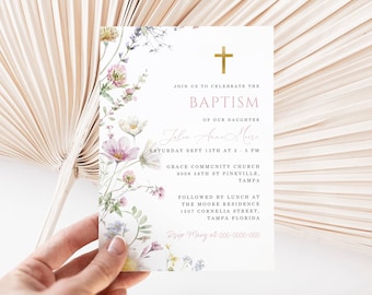 May include: A baptism invitation card with floral accents. The card features a gold cross and text that reads "Join us to celebrate the Baptism of our daughter". The card is held by a hand.