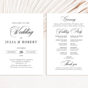 May include: Two white wedding program cards with black serif and script typography. The left card displays the names Julia and Robert, date, and location. The right card lists the ceremony order, wedding party members, and a thank you message.