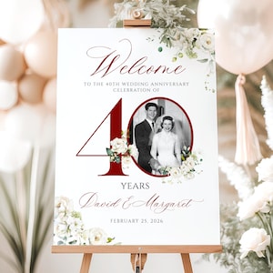 May include: A white rectangular welcome sign for a 40th wedding anniversary featuring a large dark red number 40, a black and white photograph of a couple, floral illustrations, and the text Welcome to the 40th wedding anniversary celebration of David & Margaret February 25, 2026.
