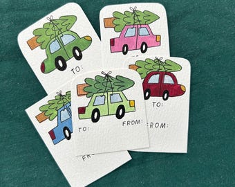 May include: A collection of Christmas gift tags featuring colorful cars with Christmas trees on top. Each tag has the words "TO:" and "FROM:" printed on it. The cars are in shades of green, pink, blue, and red.