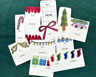 May include: A collection of hand-drawn Christmas gift tags. Designs include a candy cane, Christmas tree, car with a tree on top, gift boxes, stockings, and a bow. Each tag has space for "TO:" and "FROM:"