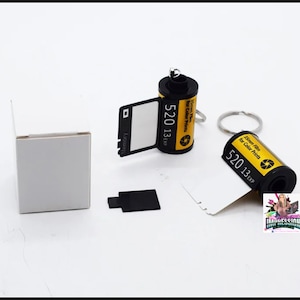 May include: Two black and yellow film canisters with keychains. The canisters are labeled "35mm Film for Color Prints 520 13 EXP".