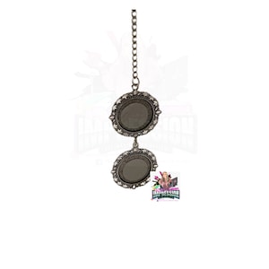 May include: A silver chain with two round mirrors attached. The mirrors have ornate silver frames.