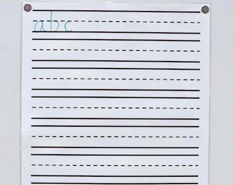 May include: A white writing practice sheet with black lines and the letters "abc" written in teal cursive. The sheet is held in place by four silver magnets. The sheet is designed for practicing handwriting.