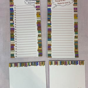 May include: A set of four notepads. Two rectangular notepads with lined paper and the text "Groceries to Buy" and "Things to do... Books to read..." are decorated with a bookshelf border. Two square notepads with a bookshelf border.