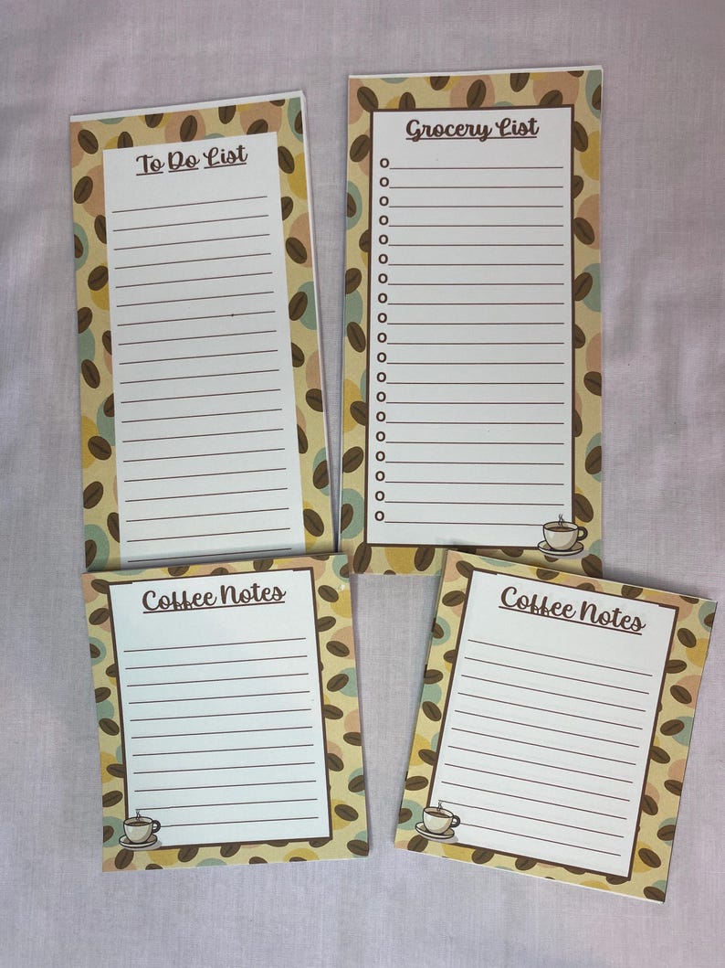 May include: Four coffee-themed notepads with lined pages. Two pads say "Coffee Notes" and two say "To Do List" and "Grocery List". The pads have a coffee bean pattern border and a small coffee cup graphic.
