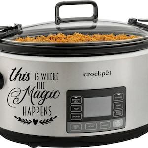 May include: A silver Crock-Pot slow cooker with a clear glass lid. The text "this is where the magic happens" is on the front. The slow cooker has a digital display and black handles.