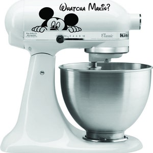 May include: White KitchenAid Classic stand mixer with a stainless steel bowl. A black and white Mickey Mouse graphic and the text "Whatcha Makin?" are on the mixer's head. The mixer has a power rating of 275 watts.