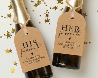May include: Two mini champagne bottles with brown paper tags. The tags have black text that reads "HIS favorite" and "HER favorite" with a small heart symbol. The text on the tags also says "Thank you for celebrating with us!"