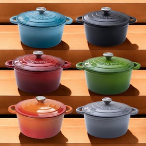 May include: A selection of cast iron Dutch ovens in a range of colours: teal, black, red, green, orange, and grey. Each pot has a matching lid with a silver knob and side handles. The pots are displayed on wooden steps.
