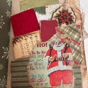 May include: A junk journal page featuring a collage of Christmas-themed paper ephemera. Elements include a vintage Santa Claus illustration with the text HO! HO HO HO!, sheet music, red snowflake-embossed cardstock, and green plaid paper.