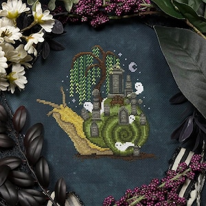May include: Cross-stitch design featuring a snail with a green shell, carrying a graveyard on its back. The snail is yellow and brown, with a weeping willow tree and white ghost figures. The background is dark blue, with white flowers and purple berries.