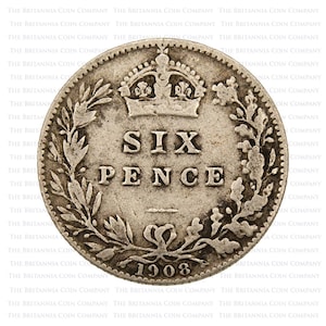 May include: A silver Six Pence coin from 1908. The coin displays the text "SIX PENCE" under a crown, framed by floral patterns. The year "1908" is at the base. The coin has a detailed, textured surface.