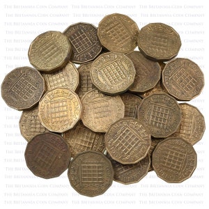 May include: A pile of 1960s British three pence coins. The coins are copper-colored and have a design of the Royal Coat of Arms with the words "THREE PENCE" and "1960" around the edge.