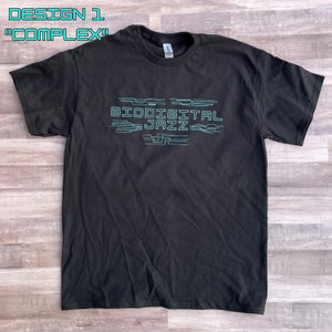 May include: Black t-shirt with a teal blue graphic design that says "Biodigital Jazz" with stylised lines.