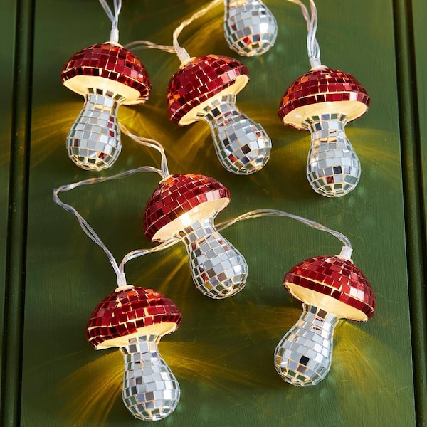 May include: A string of decorative lights featuring mushroom-shaped ornaments covered in small, reflective mirror tiles. The mushroom caps are composed of red mirror tiles, while the stems are made of silver mirror tiles, emitting a warm glow.