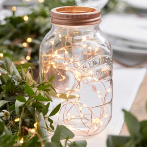 May include: A clear glass jar with a copper lid filled with warm white fairy lights. The jar has the text "Kilner Est 1883" printed on the side.
