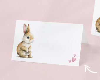 May include: Printable blank place cards featuring a watercolor illustration of a brown bunny with pink hearts. The text "Download & Print" and "Blank Templates Print and Fill In!" is also included in the image.