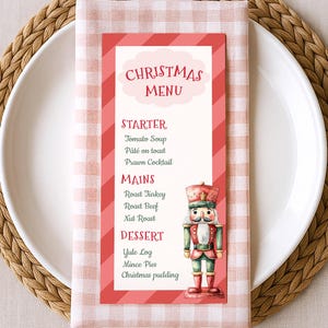 May include: A Christmas menu card with a red and white striped border and a watercolor illustration of a nutcracker. The menu lists starters, mains, and desserts, including roast turkey and Christmas pudding.