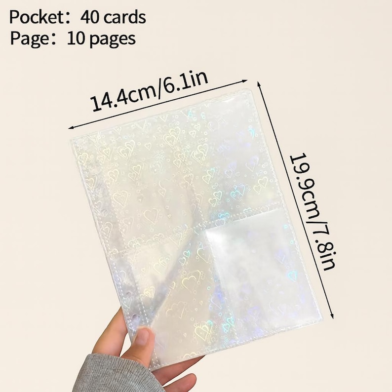 May include: A clear, iridescent card holder with a heart pattern, held by a person. The holder is 14.4cm/6.1in wide and 19.9cm/7.8in tall, with 40 card pockets across 10 pages. Text on the image reads "Pocket: 40 cards Page: 10 pages."