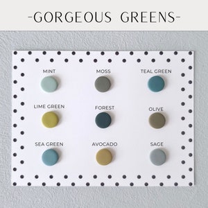May include: A white card with black polka dots features nine circular color samples in various shades of green. The text "-GORGEOUS GREENS-" is at the top. Each sample is labeled with a green color name, such as "Mint" and "Avocado".