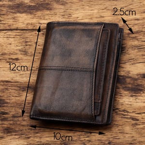 May include: A brown leather wallet with a stitched design. The wallet measures 12 inches by 10 inches by 2.5 inches.