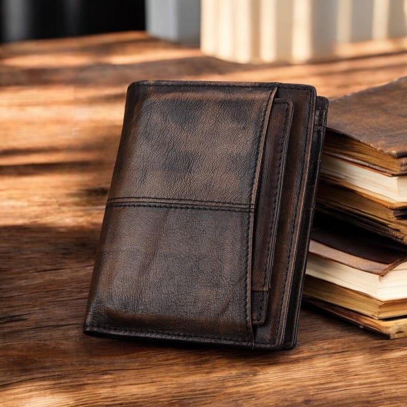 May include: A brown leather wallet with multiple compartments and a distressed finish.
